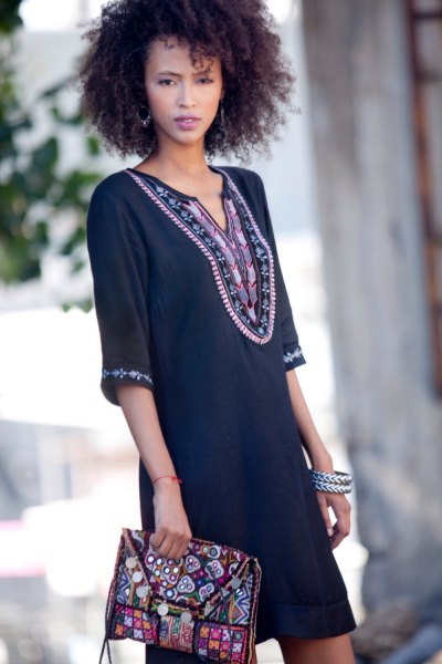 black tunic dress with tribal print and matching clutch