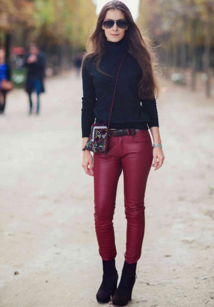 black turtleneck with red, narrow leather pants