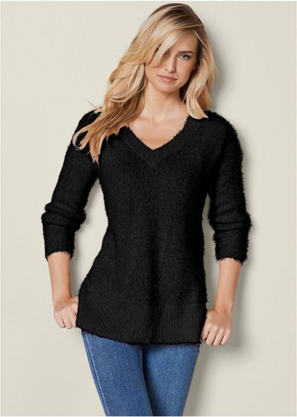 black slim fit knitted sweater with V-neckline and blue skinny jeans