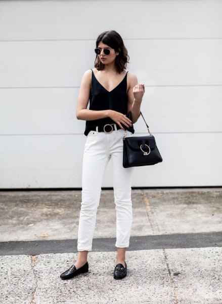 black vest top with V-neck with white jeans and slippers with straight legs and cuffs