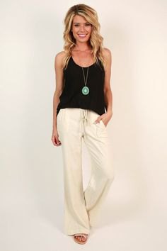 black vest top with white flared pants