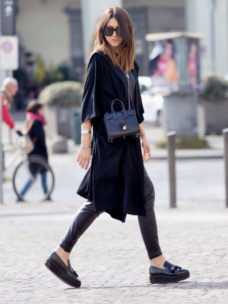 black wide tunic dress with half sleeves, leather gaiters and platform sneakers