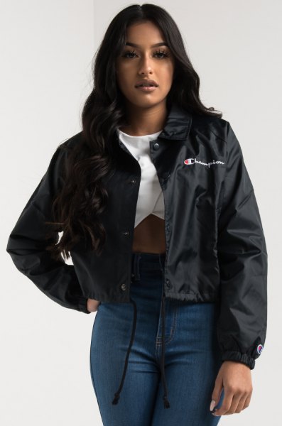 black windbreaker with white graphic t-shirt and tall skinny jeans