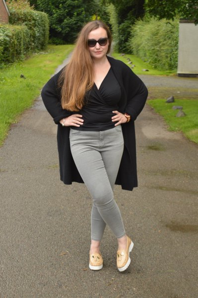 black wrap blouse with gray slim fit jeans and blushing pink slippers