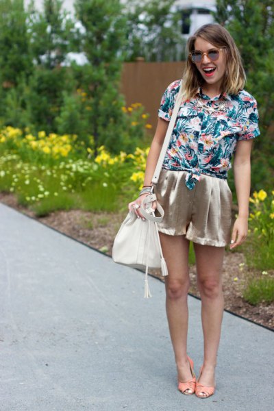 blue and white shirt with floral pattern and rose gold mini silk shorts