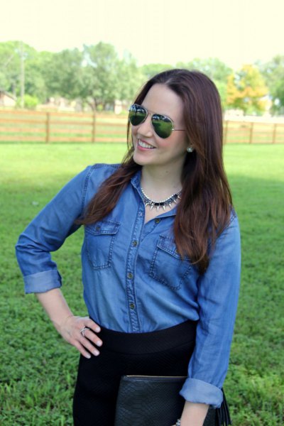 blue chambray shirt with buttons and black high-rise jeans