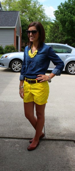 blue chambray shirt with buttons and yellow shorts