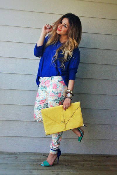 blue, chunky sweater with white trousers with tapered legs and floral pattern