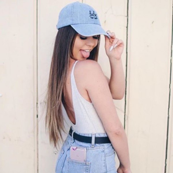 blue denim baseball cap with white tank top and high-waisted shorts