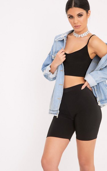 blue denim jacket with black crop top and high-waisted shorts