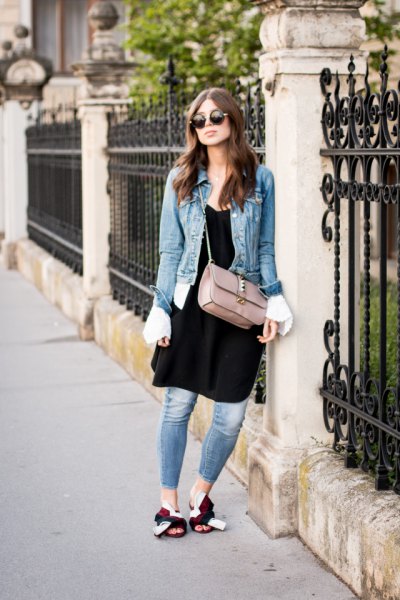 blue denim jacket with black tunic dress and gold slippers