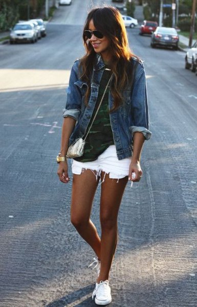 blue denim jacket with camouflage shirt and ripped white denim shorts