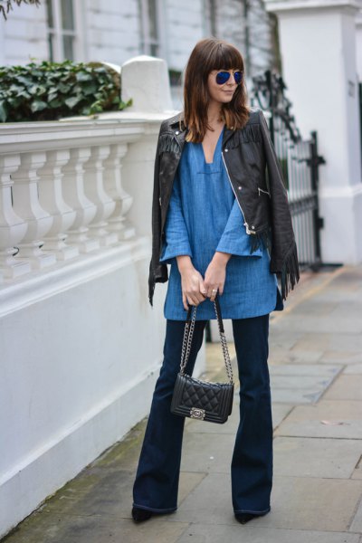 blue tunic with V-neck with black leather jacket and flared jeans