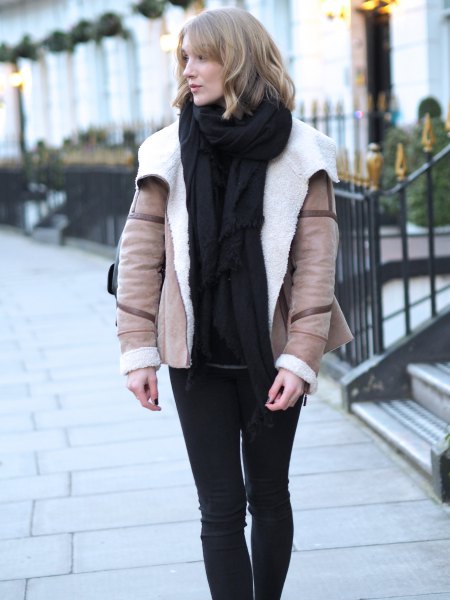 blushing pink aviator jacket with black sweater and knitted scarf