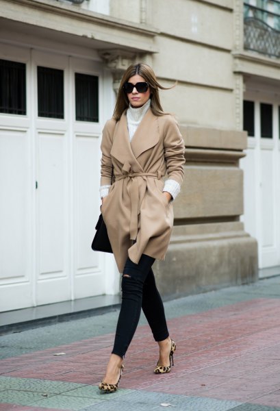 Blushing pink wool coat with a belt and black skinny jeans