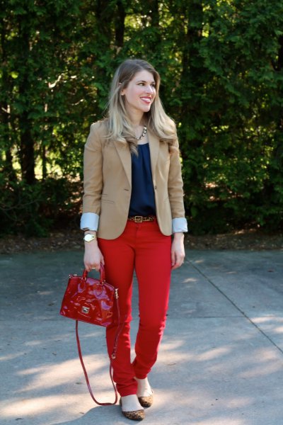 blushing pink blazer with navy blouse and red belt