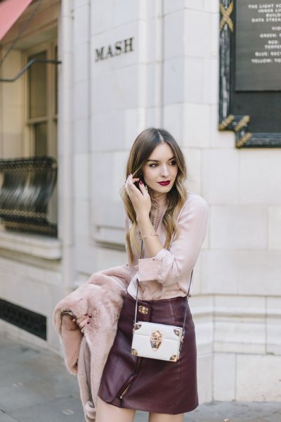 blushing pink blouse with black leather mini skirt