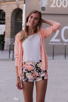 blushing pink cardigan with white t-shirt and black floral cotton shorts