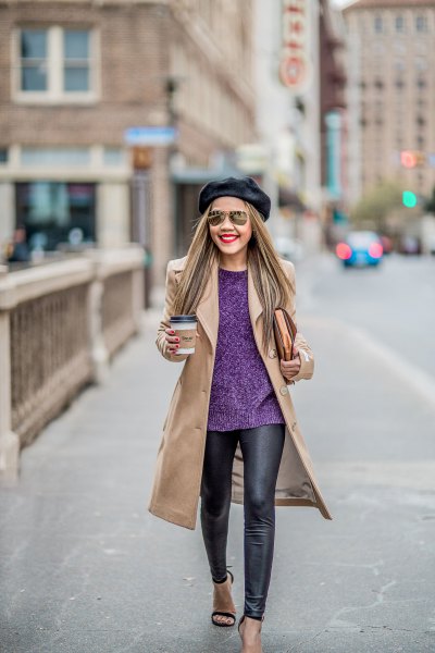 Blushing pink coat with a dark blue sweater and black leather gaiters