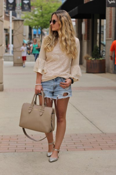 blushing pink lace blouse with bell sleeves and light blue, ripped denim shorts