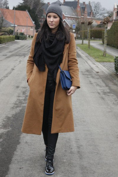 Blushing pink long wool coat with a black scarf and matching skinny jeans