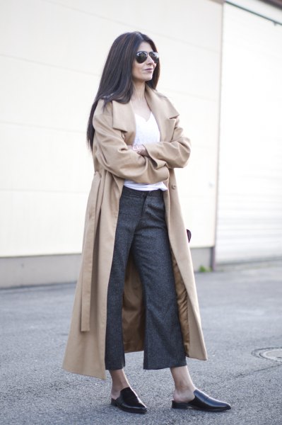 blushing pink longline trench coat with belt and gray, flared chinos and slippers