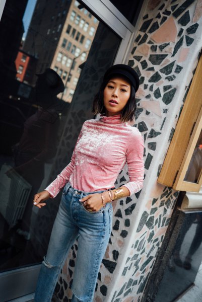 blush pink long-sleeved blouse with a stand-up collar and blue, narrow-cut jeans