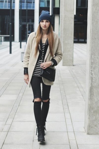 Blushing pink wool coat with a black and white striped tank top and torn knee jeans