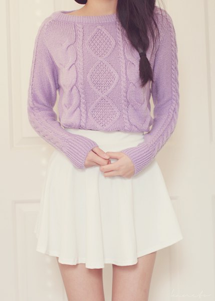 Cable knit sweater with boat neckline and white mini pleated skirt