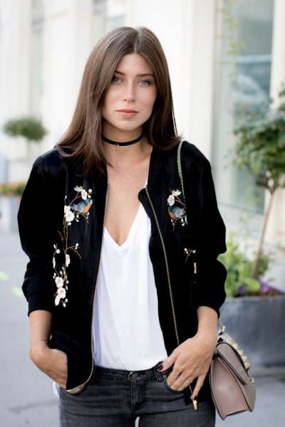 Bomber jacket with a low-cut white vest top and black collar