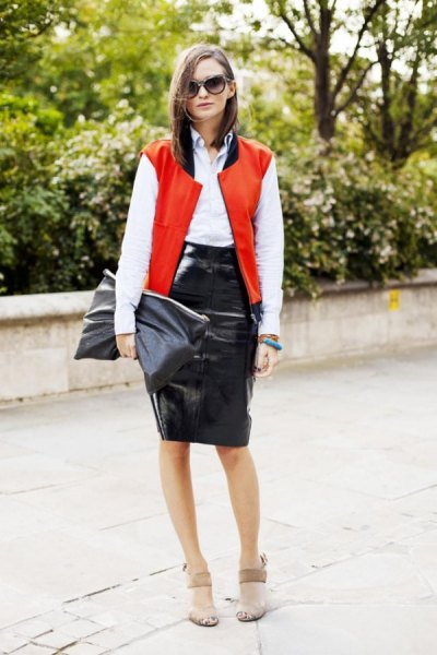 bright red sleeveless college jacket with white shirt with buttons and black leather skirt