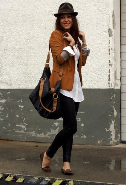 brown blazer with white, oversized shirt with buttons and black floppy hat