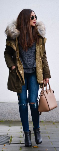 brown long-line bomber jacket with hood made of faux fur and ripped skinny jeans