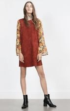brown mini tunic dress with floral pattern and black ankle boots