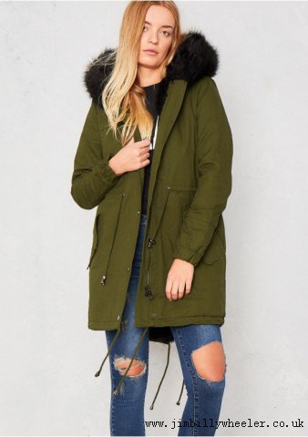 Parka coat with brown fur and ripped jeans
