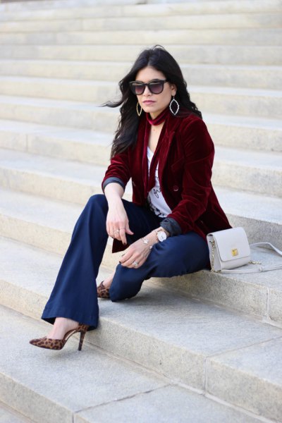brown jacket with white t-shirt with scoop neckline and flared navy trousers