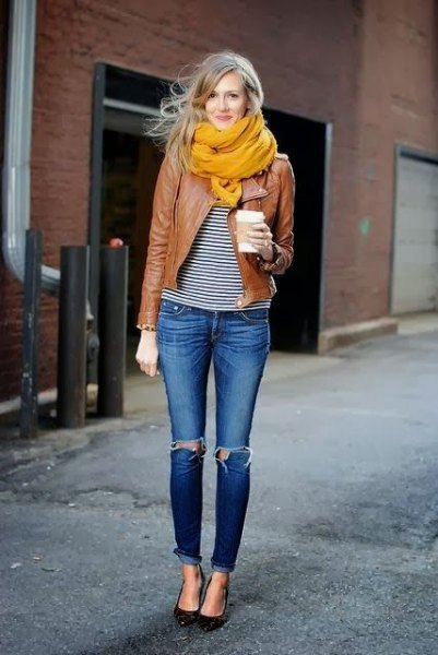 brown leather jacket with black and white striped t-shirt and orange scarf