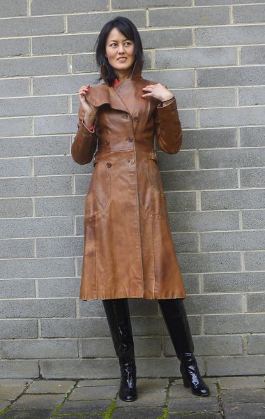 brown leather trench coat with pink mock neck sweater