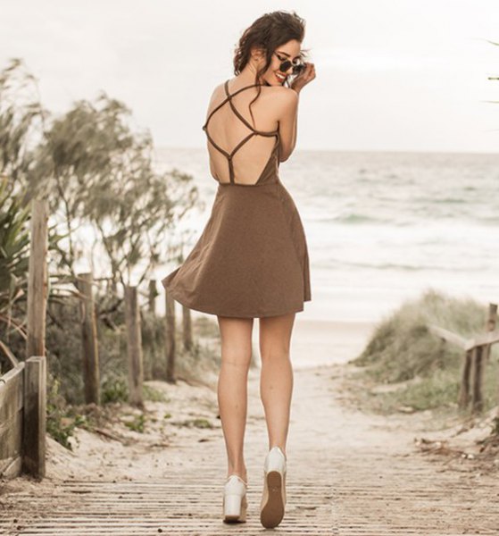 brown mini dress with open back and flared mini dress with white platform heels