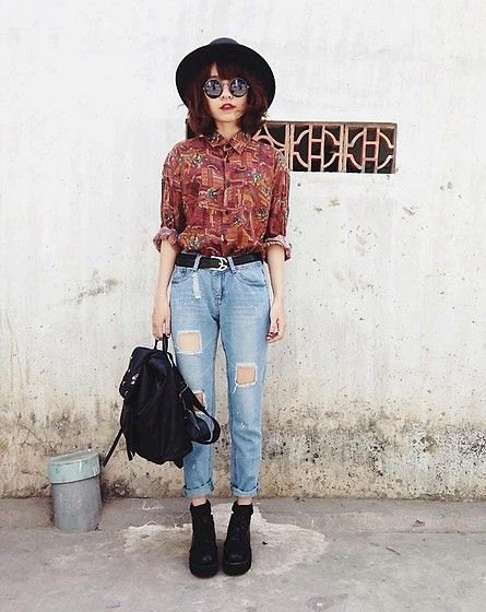 brown printed vintage shirt with buttons and high-waisted, ripped jeans