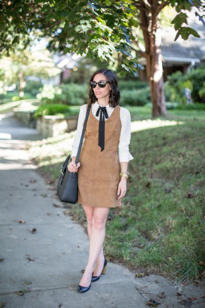 brown suede shift dress over white bow shirt