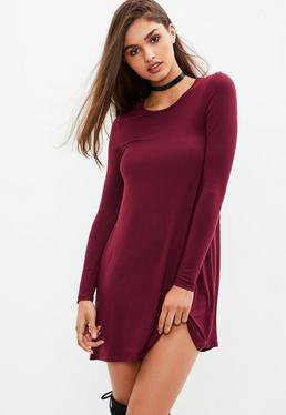 Burgundy, long-sleeved, figure-hugging T-shirt dress with over-the-knee boots