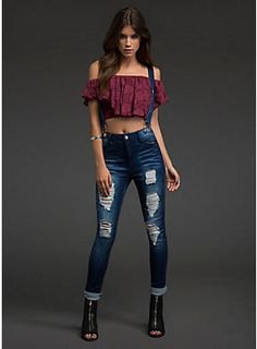 Burgundy off-the-shoulder top with blue ripped suspender jeans