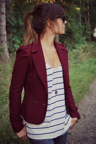 Burgundy red short blazer with a black and white vest top with a scoop neckline