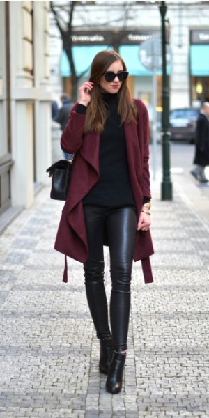 Burgundy trench coat with black turtleneck and leather gaiters