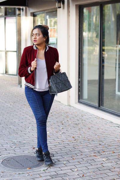 Burgundy velvet blazer with a gray t-shirt with a scoop neckline and blue slim fit jeans