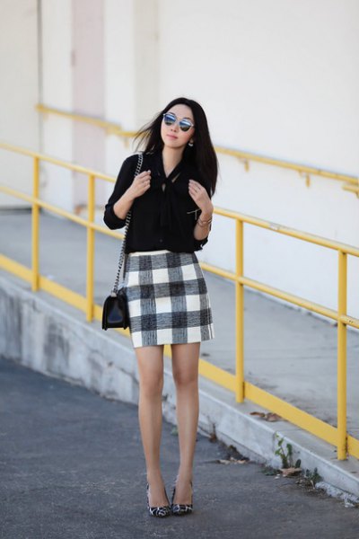 Blouse with button closure and black checked mini skirt