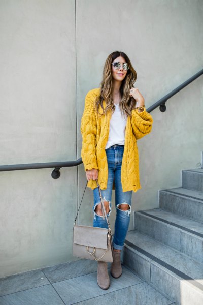 Cable knit lemon yellow cardigan with blue destroyed jeans
