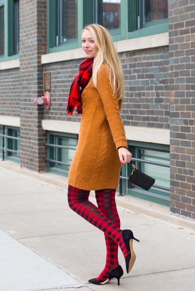 Cable knit sweater dress with red and black checked leggings