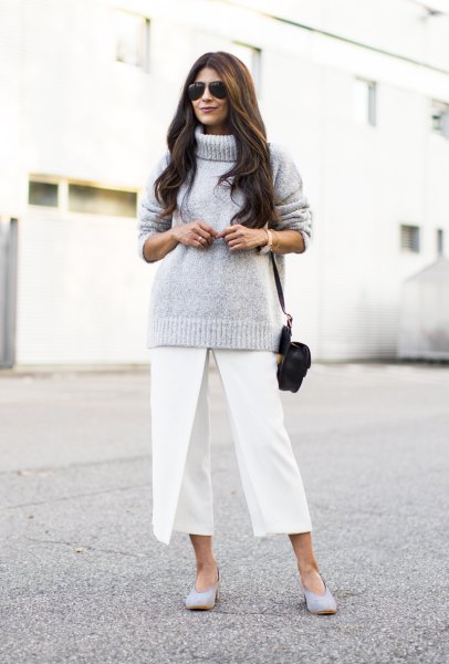 gray knitted sweater with turtleneck and white, cropped pants with wide legs